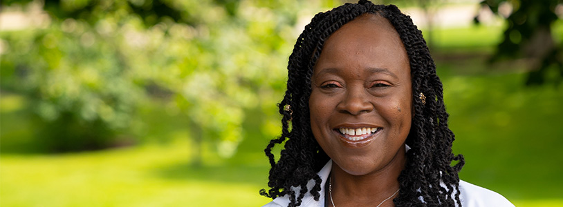 Dianne Junior in white lab coat, smiling