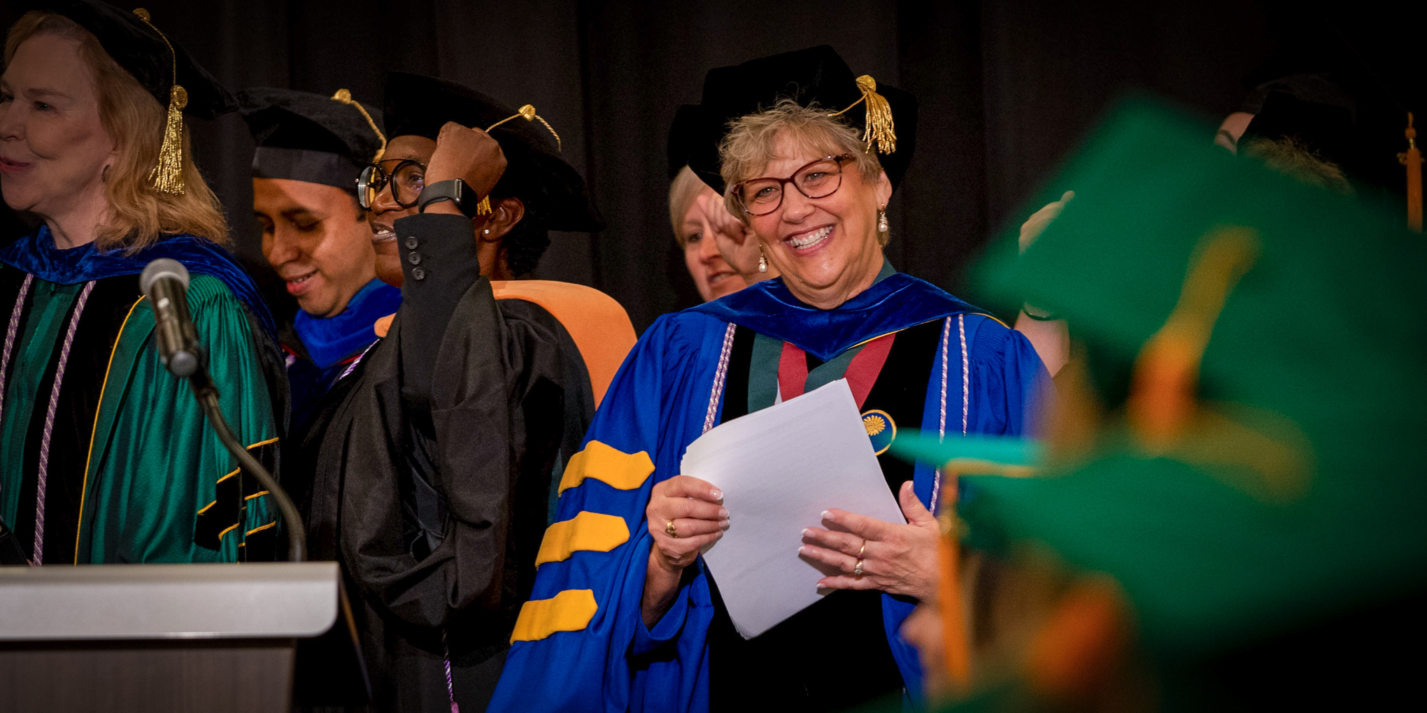 Dean Leigh Small celebrates a CON graduation ceremony with students, faculty, and guests.