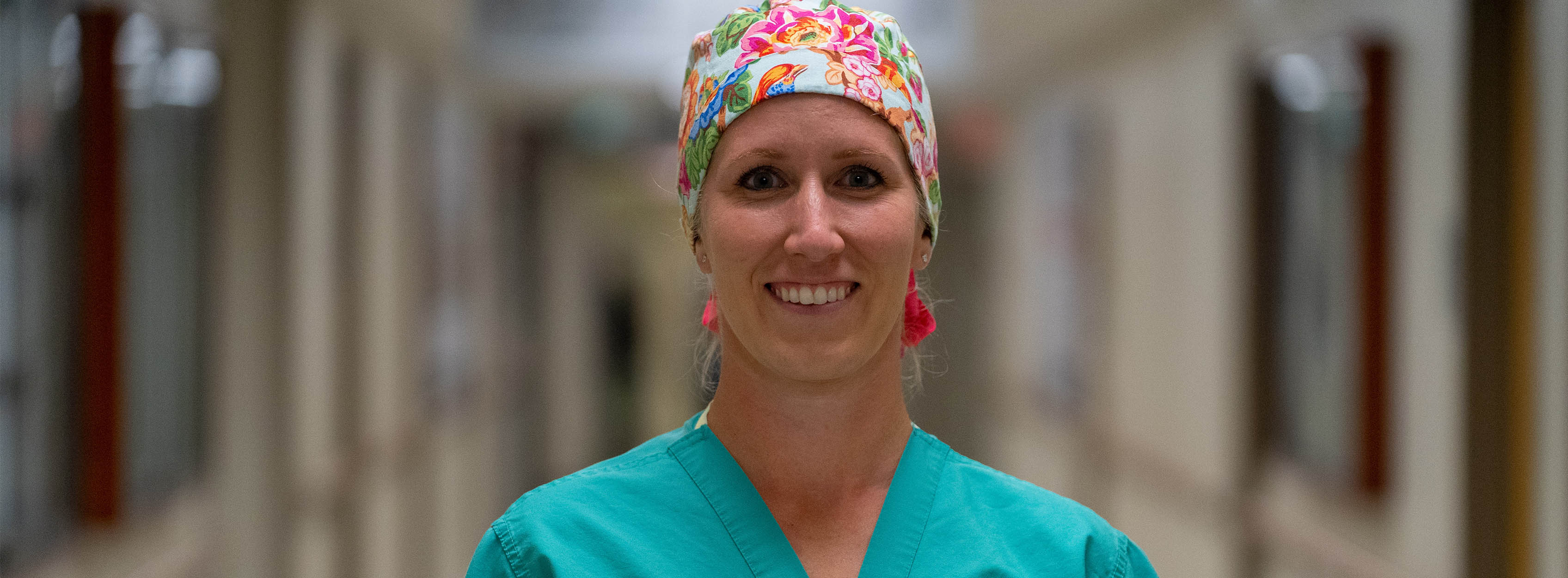 Tamara Lemons in scrubs in hospital hallway.