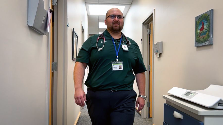 Jeremy walking down a hallway in the clinic.