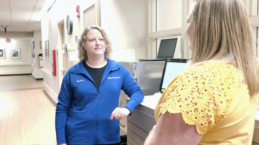 Meredith, talking to a colleague in the hospital hallway.